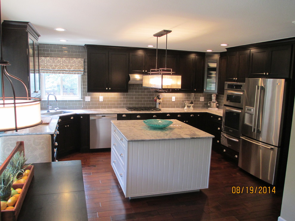 Kitchen - mid-sized transitional u-shaped dark wood floor kitchen idea in Denver with an undermount sink, shaker cabinets, dark wood cabinets, marble countertops, gray backsplash, subway tile backsplash, stainless steel appliances and an island