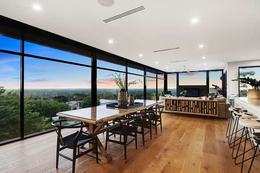 Inspiration for a contemporary open plan dining in Adelaide with white walls, medium hardwood floors and brown floor.
