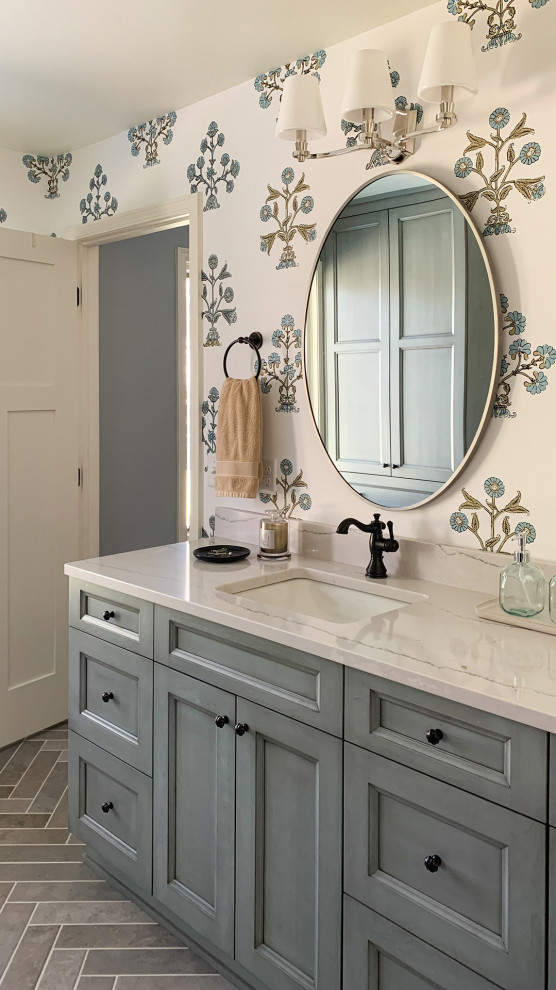 This is an example of a large master bathroom in Minneapolis with shaker cabinets, blue cabinets, multi-coloured walls, brick floors, an undermount sink, engineered quartz benchtops, grey floor, white benchtops, a double vanity, a built-in vanity and wallpaper.