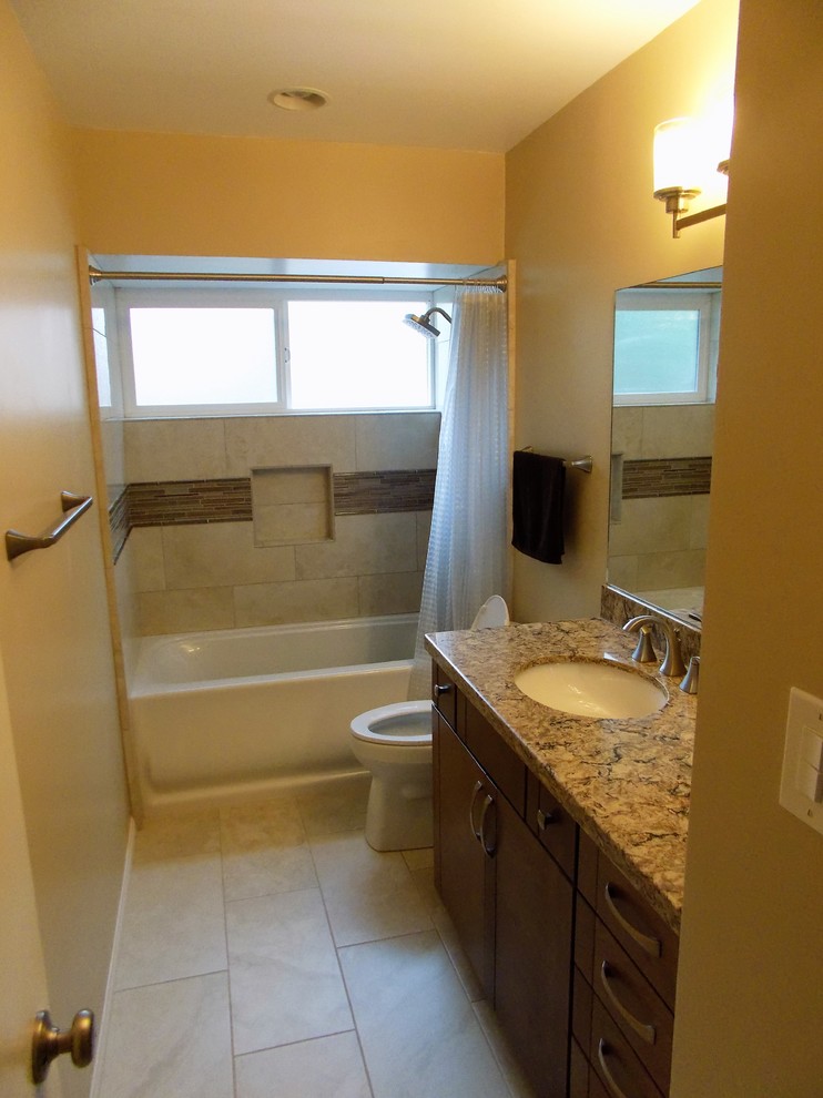 Design ideas for a mid-sized transitional kids bathroom in San Diego with flat-panel cabinets, medium wood cabinets, an alcove tub, a one-piece toilet, beige tile, porcelain tile, beige walls, porcelain floors, an undermount sink and engineered quartz benchtops.