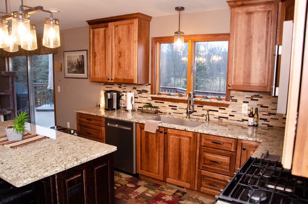 Eat-in kitchen - mid-sized transitional u-shaped laminate floor eat-in kitchen idea in Detroit with an undermount sink, medium tone wood cabinets, granite countertops, multicolored backsplash, mosaic tile backsplash, stainless steel appliances, an island and beige countertops