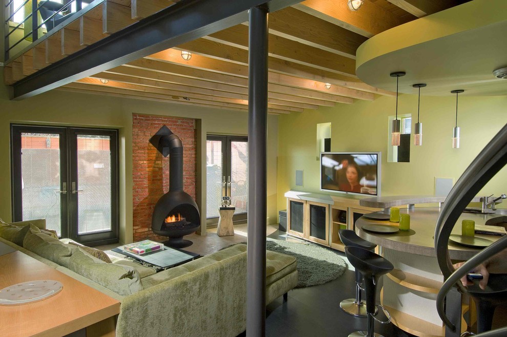 Contemporary living room in Philadelphia with green walls and a wood stove.