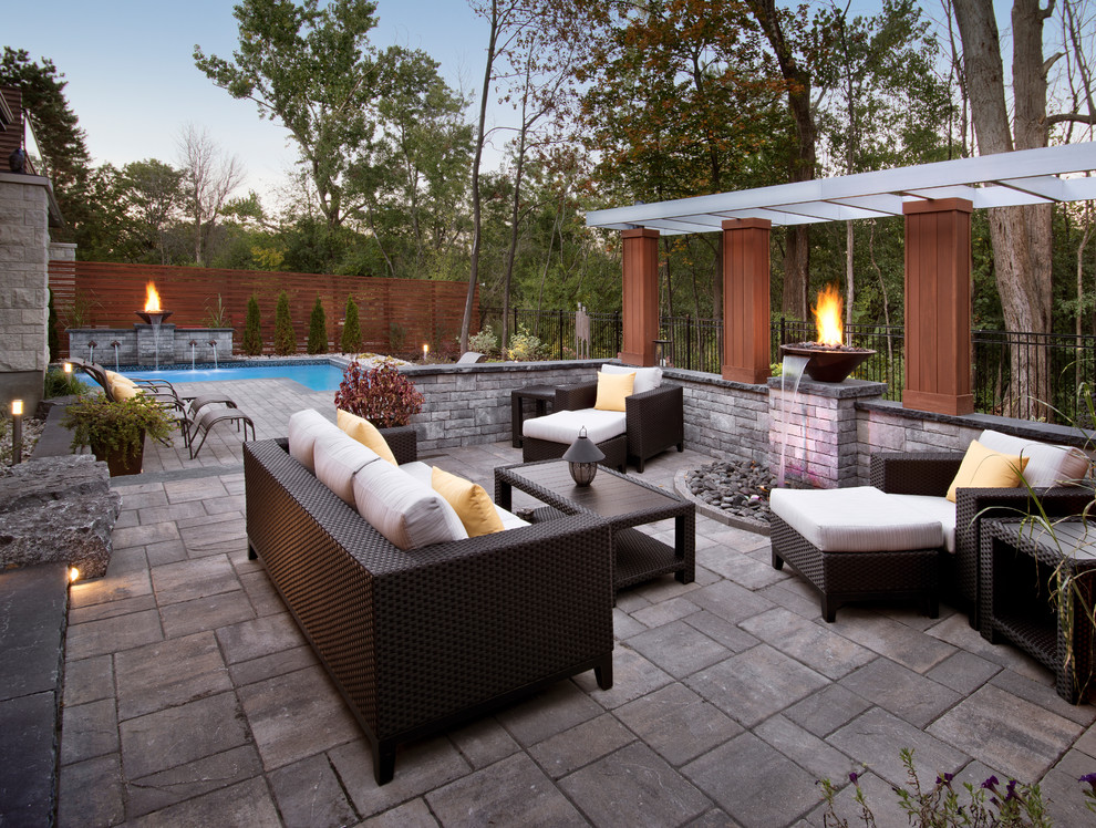 Photo of a contemporary back patio in Ottawa with a fire feature and no cover.