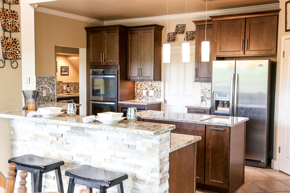 Mid-sized transitional single-wall porcelain tile and beige floor eat-in kitchen photo in Austin with a farmhouse sink, shaker cabinets, dark wood cabinets, glass countertops, multicolored backsplash, glass tile backsplash, stainless steel appliances, an island and multicolored countertops