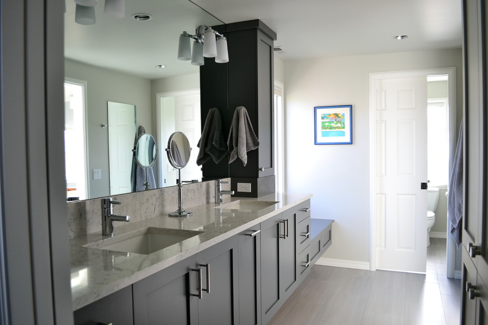 Inspiration for a large transitional bathroom in Seattle with an undermount sink, shaker cabinets, grey cabinets, engineered quartz benchtops, an alcove shower, grey walls and porcelain floors.