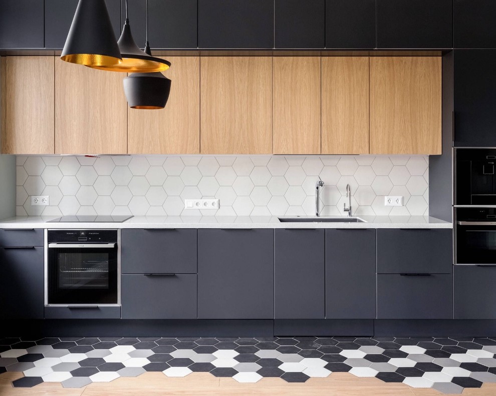 Inspiration for a mid-sized contemporary l-shaped separate kitchen in Toronto with an undermount sink, flat-panel cabinets, white splashback, light wood cabinets, quartz benchtops, porcelain splashback, black appliances, porcelain floors, with island, multi-coloured floor and grey benchtop.
