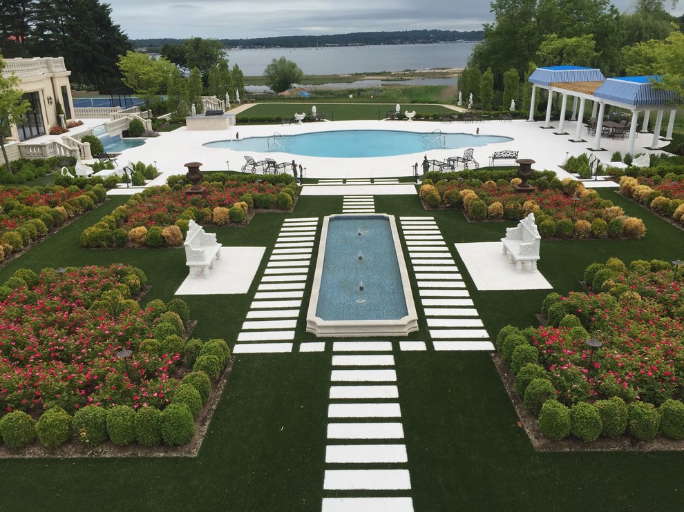 Pool - large backyard stone and custom-shaped lap pool idea in New York