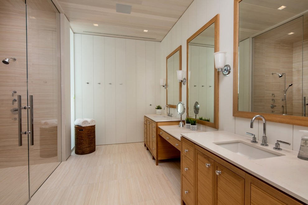 Design ideas for a large beach style master bathroom in Toronto with medium wood cabinets, white walls, ceramic floors, a hinged shower door, beige benchtops, a curbless shower, beige tile, an undermount sink, beige floor and shaker cabinets.