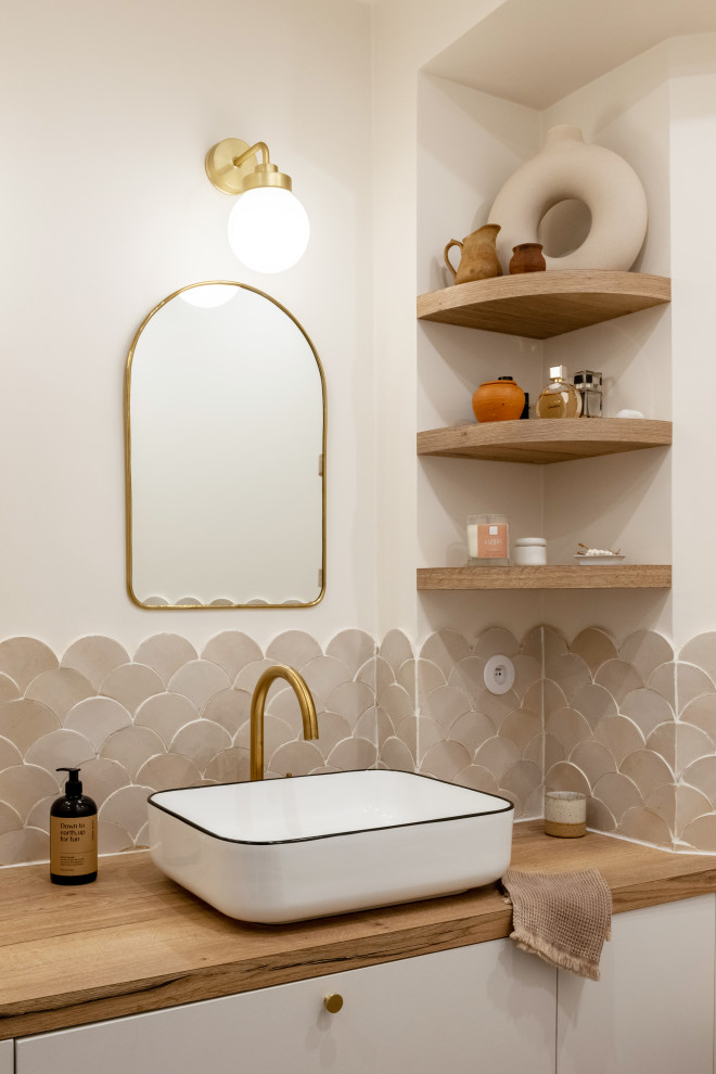 This is an example of a small scandi ensuite bathroom in Paris with beige cabinets, a submerged bath, a corner shower, beige tiles, terracotta tiles, white walls, cement flooring, a console sink, wooden worktops, brown floors, a hinged door, brown worktops, a single sink, a floating vanity unit and flat-panel cabinets.