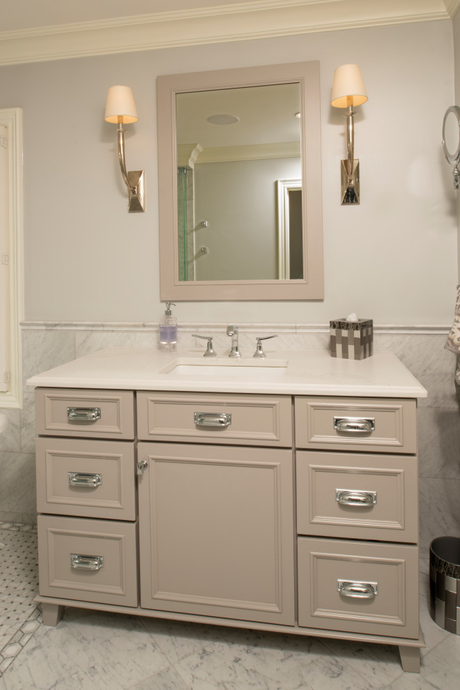 Inspiration for a large transitional master bathroom in Detroit with furniture-like cabinets, grey cabinets, a freestanding tub, an open shower, a two-piece toilet, gray tile, stone tile, grey walls, marble floors, an undermount sink, engineered quartz benchtops, grey floor, an open shower and white benchtops.