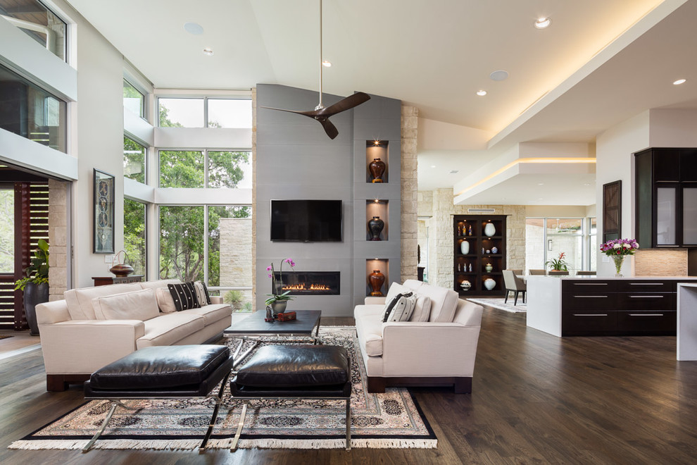 Inspiration for a contemporary open concept living room in Austin with white walls, dark hardwood floors, a ribbon fireplace and a wall-mounted tv.