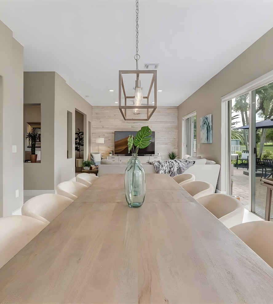Mid-sized transitional open plan dining in Miami with beige walls, porcelain floors, beige floor and wood walls.