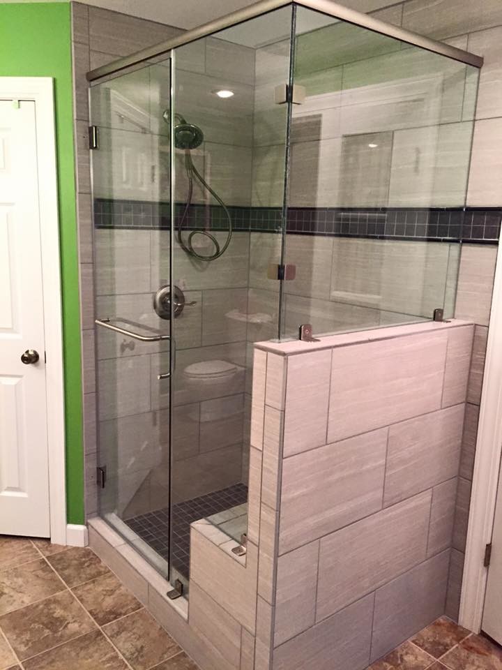 Example of a mid-sized transitional master gray tile and slate tile ceramic tile and brown floor corner shower design in Chicago with gray walls and a hinged shower door