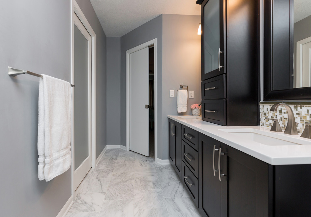 Design ideas for a mid-sized transitional master bathroom in Other with an undermount sink, recessed-panel cabinets, dark wood cabinets, quartzite benchtops, a curbless shower, a one-piece toilet, gray tile, mosaic tile, grey walls and marble floors.