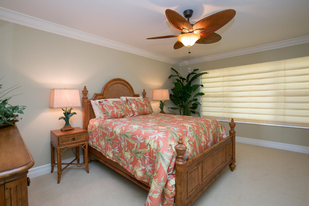 Mid-sized beach style guest bedroom in Tampa with beige walls and carpet.