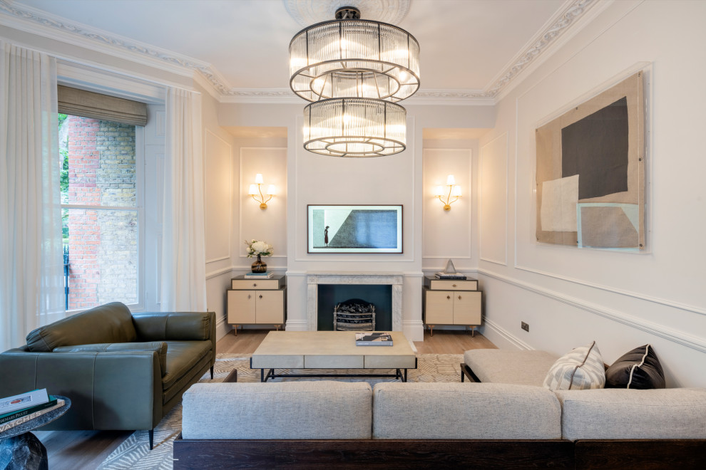 This is an example of a medium sized classic open plan living room in London with beige walls, laminate floors, a standard fireplace, a stone fireplace surround, a wall mounted tv, beige floors, panelled walls and feature lighting.
