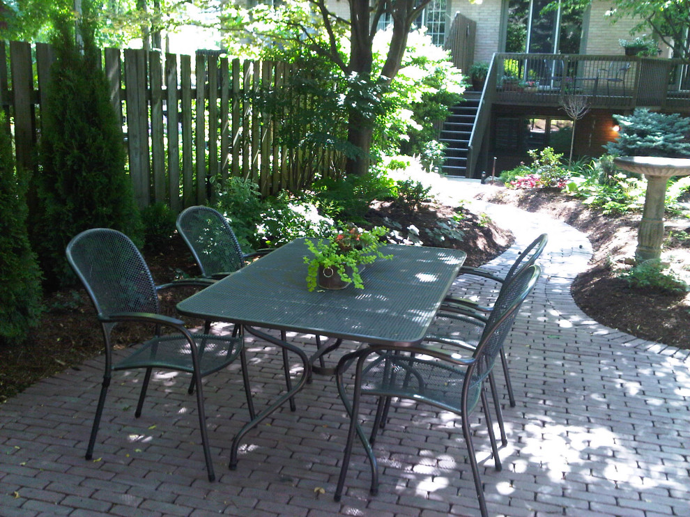 Photo of a mid-sized backyard shaded garden for summer in Toronto with with flowerbed and brick pavers.