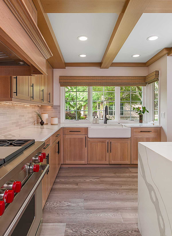 Photo of a large l-shaped separate kitchen in Detroit with a farmhouse sink, shaker cabinets, medium wood cabinets, quartz benchtops, beige splashback, subway tile splashback, panelled appliances, medium hardwood floors, with island, white benchtop, coffered and brown floor.
