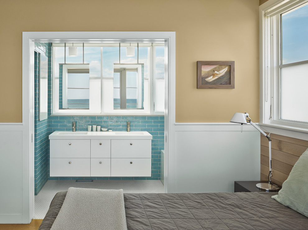 This is an example of a mid-sized beach style master bathroom in Philadelphia with flat-panel cabinets, white cabinets, blue tile, mosaic tile floors, an undermount sink, a drop-in tub, an alcove shower, a one-piece toilet, porcelain tile, blue walls, quartzite benchtops and white benchtops.