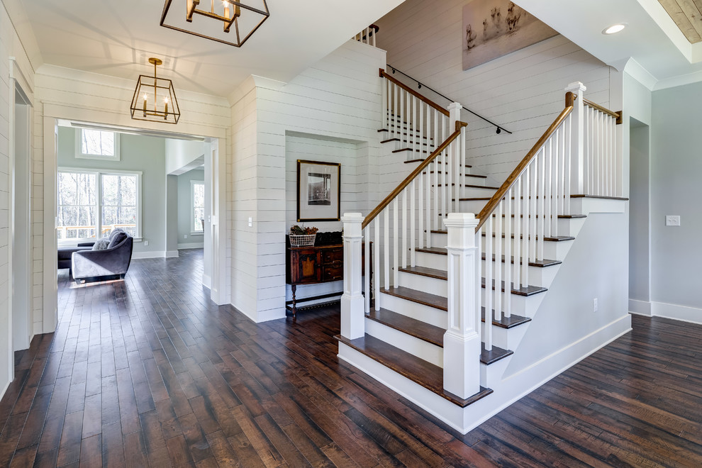 Photo of a transitional wood l-shaped staircase in Atlanta with painted wood risers.