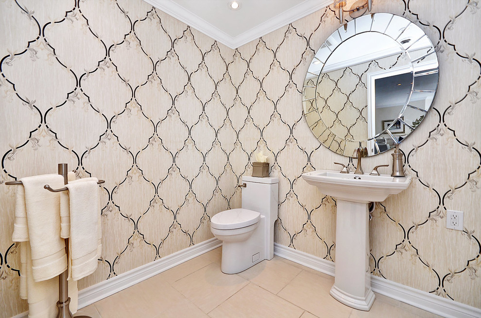 Mid-sized traditional powder room in Ottawa with a pedestal sink, a one-piece toilet, beige tile, beige walls and porcelain floors.