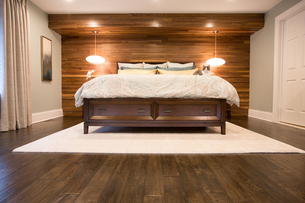 This is an example of a mid-sized transitional master bedroom in Detroit with dark hardwood floors, no fireplace, brown floor and beige walls.