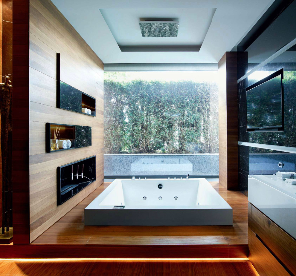 Design ideas for a large contemporary master bathroom in Venice with open cabinets, a hot tub and medium hardwood floors.