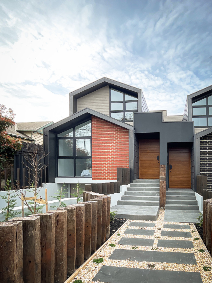 Mid-sized trendy brown three-story brick and shingle exterior home photo in Melbourne with a shingle roof and a black roof