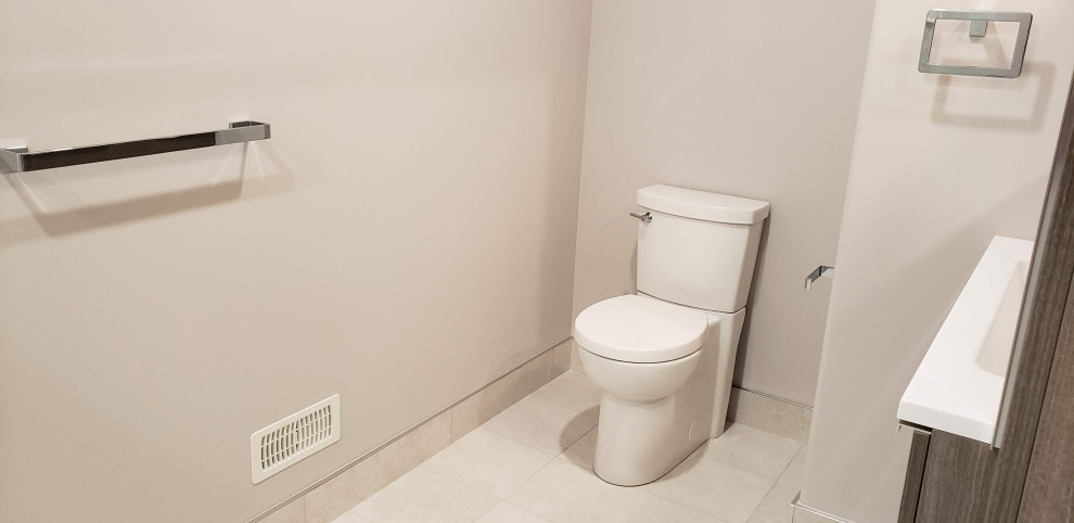 Bathroom - large transitional porcelain tile, white floor and single-sink bathroom idea with medium tone wood cabinets, a one-piece toilet, white walls, an integrated sink, quartzite countertops, white countertops and a floating vanity