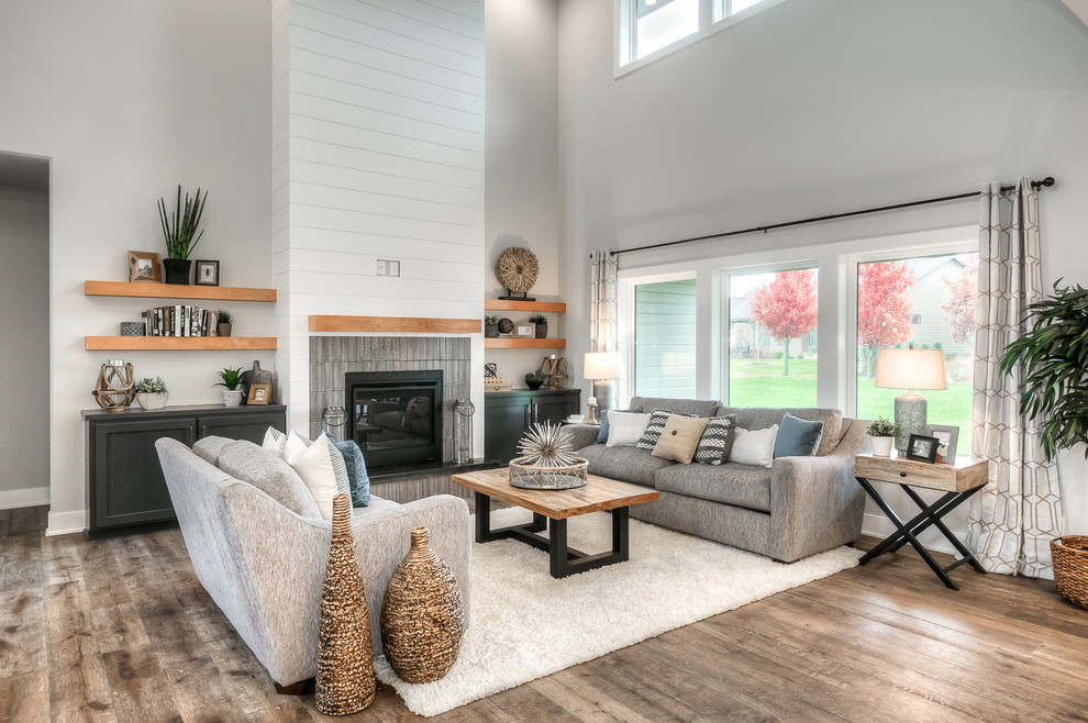 Design ideas for a country living room in Omaha with grey walls and light hardwood floors.