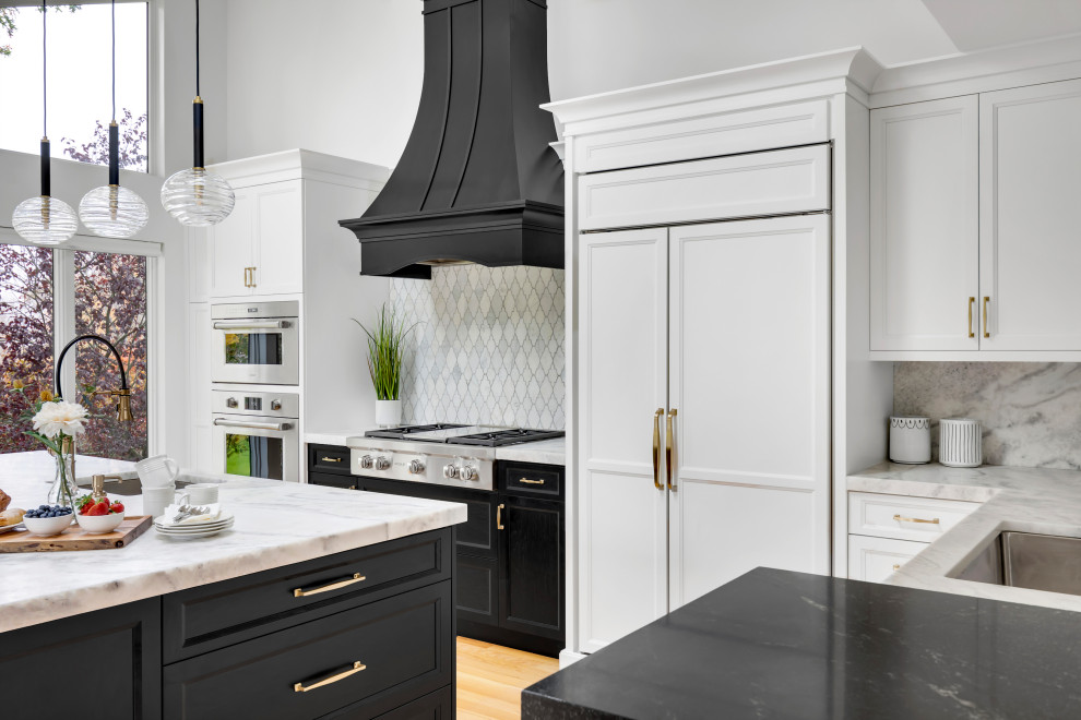 Design ideas for a large transitional l-shaped eat-in kitchen in New York with an undermount sink, shaker cabinets, white cabinets, quartz benchtops, white splashback, marble splashback, panelled appliances, light hardwood floors, with island, beige floor, white benchtop and vaulted.