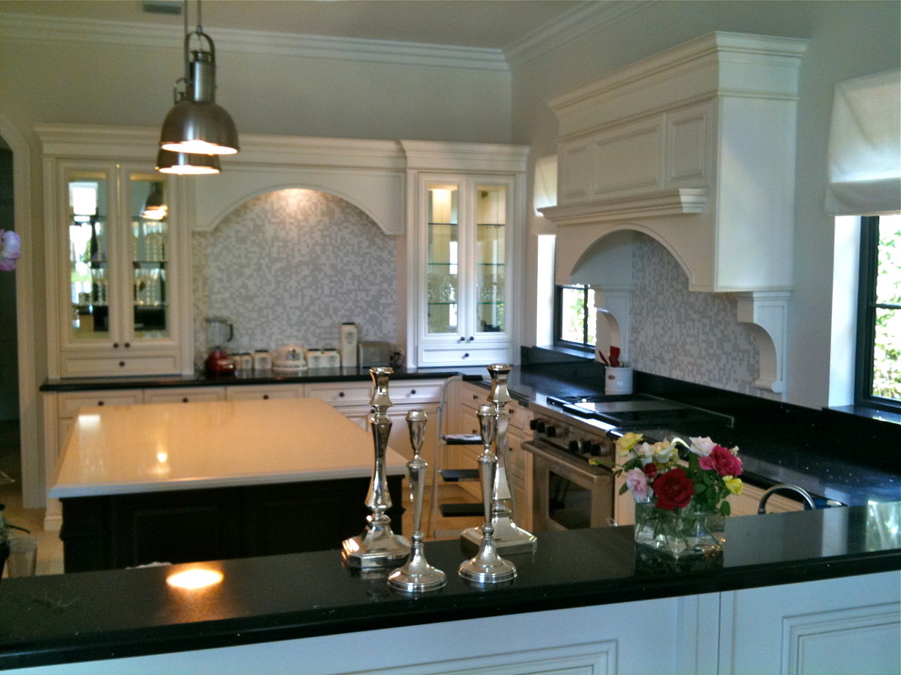 Large transitional u-shaped ceramic tile and beige floor open concept kitchen photo in Miami with a single-bowl sink, raised-panel cabinets, white cabinets, quartzite countertops, multicolored backsplash, stone tile backsplash, stainless steel appliances and an island