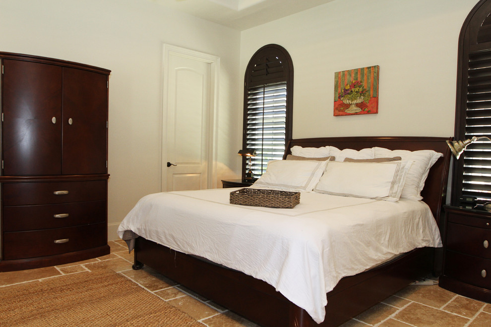 This is an example of a mid-sized traditional guest bedroom in Houston with white walls, ceramic floors and no fireplace.
