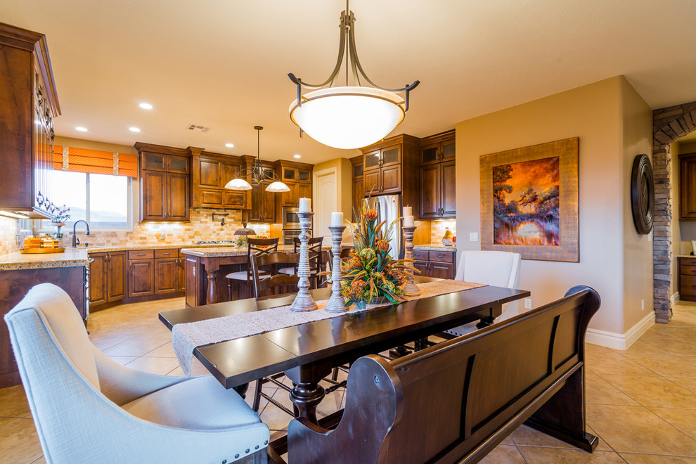 This is an example of a large country u-shaped eat-in kitchen in Salt Lake City with with island, raised-panel cabinets, dark wood cabinets, granite benchtops, beige splashback, subway tile splashback, stainless steel appliances, a double-bowl sink and ceramic floors.