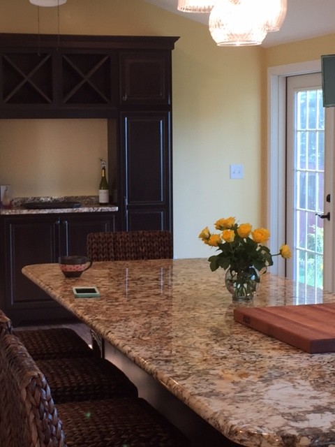 Inspiration for a large transitional l-shaped eat-in kitchen remodel in Boston with raised-panel cabinets, medium tone wood cabinets, granite countertops, white backsplash, subway tile backsplash, stainless steel appliances and an island
