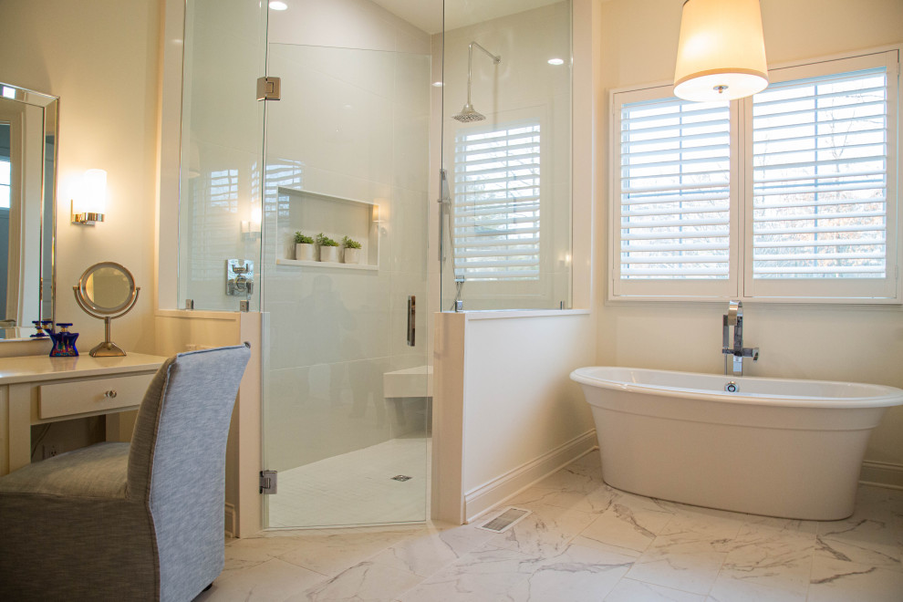 Design ideas for a large traditional ensuite bathroom in Indianapolis with a freestanding bath, an alcove shower, beige tiles, porcelain tiles, beige walls, marble flooring, multi-coloured floors, a hinged door and a wall niche.