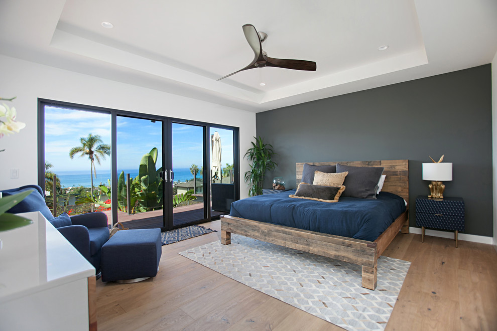 Inspiration for a contemporary master bedroom in San Diego with white walls, light hardwood floors and beige floor.