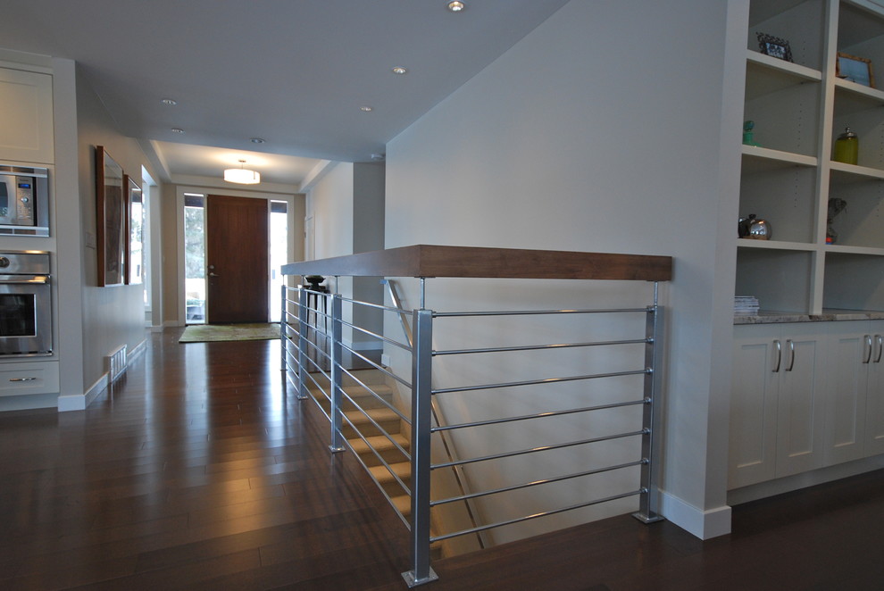 Photo of a mid-sized modern carpeted straight staircase in Edmonton with carpet risers and mixed railing.