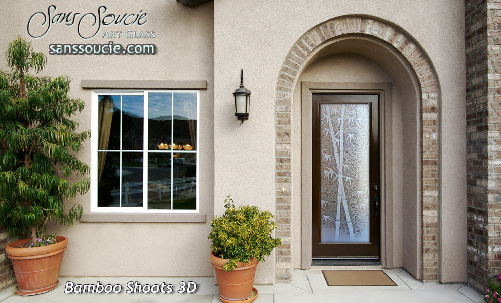 Inspiration for a large travertine floor entryway remodel in Other with beige walls and a glass front door