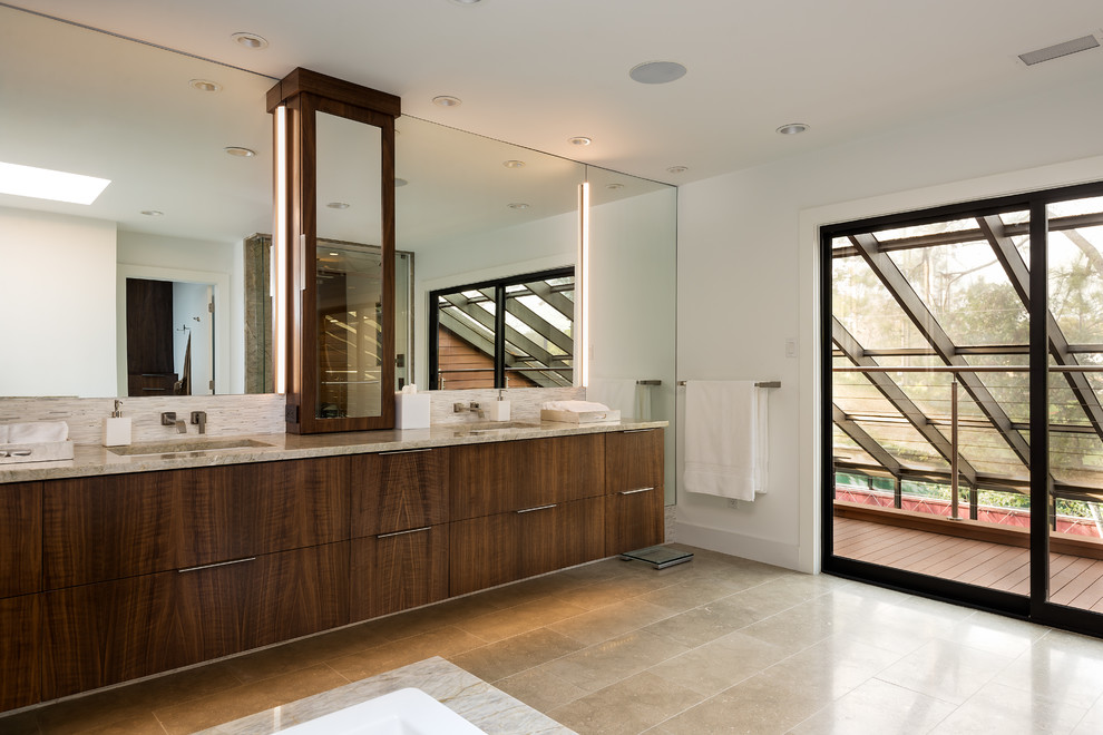 This is an example of a large contemporary master bathroom in Houston with an undermount sink, flat-panel cabinets, dark wood cabinets, beige tile, white walls and porcelain floors.