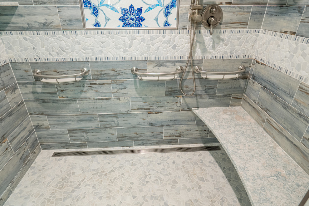 Walk-in shower - mid-sized transitional 3/4 blue tile and ceramic tile ceramic tile and blue floor walk-in shower idea with recessed-panel cabinets, white cabinets, blue walls, an undermount sink, quartz countertops, a hinged shower door and gray countertops