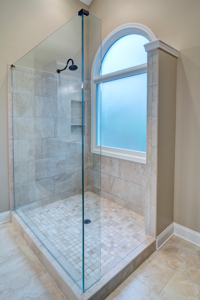 Design ideas for a mid-sized traditional master bathroom in Atlanta with a corner shower, beige tile, stone tile, beige walls and porcelain floors.