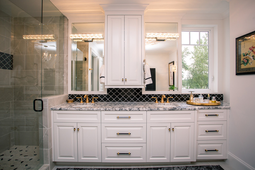 This is an example of a mid-sized traditional master bathroom in Portland with a built-in vanity, raised-panel cabinets, white cabinets, an open shower, black tile, a hinged shower door, multi-coloured benchtops, a double vanity, white walls, laminate floors, a drop-in sink and grey floor.