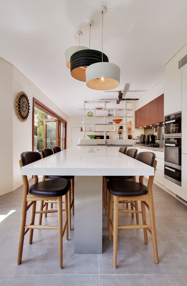 This is an example of a large contemporary open plan dining in Sydney with concrete floors, beige walls and no fireplace.