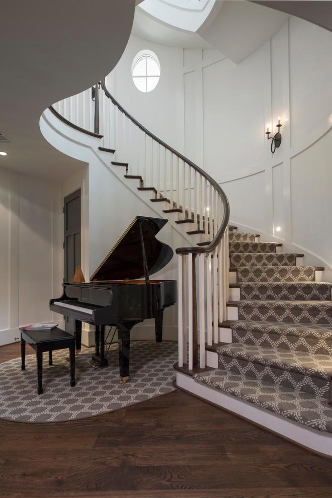 Design ideas for an expansive transitional carpeted curved staircase in Atlanta with carpet risers and wood railing.