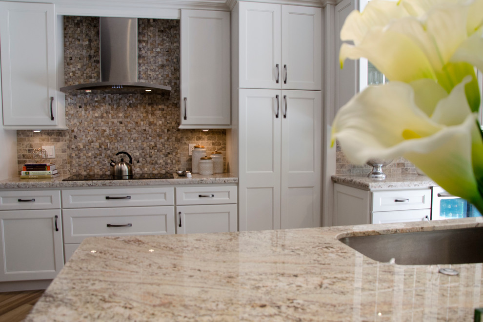 Example of a large transitional porcelain tile open concept kitchen design in Miami with an undermount sink, shaker cabinets, granite countertops, multicolored backsplash, stone tile backsplash, stainless steel appliances and an island