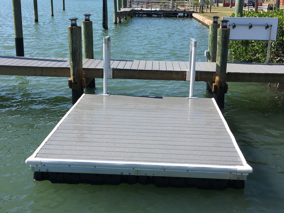 Photo of a small tropical backyard deck in Tampa with with dock and no cover.