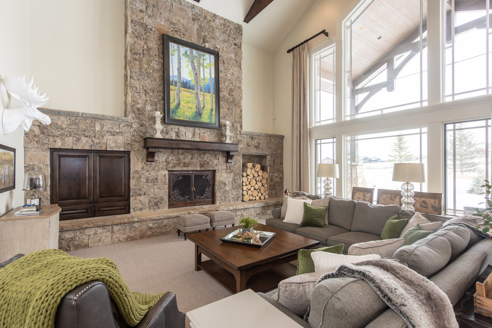 Design ideas for a country living room in Salt Lake City with white walls, carpet, a standard fireplace, a stone fireplace surround and beige floor.