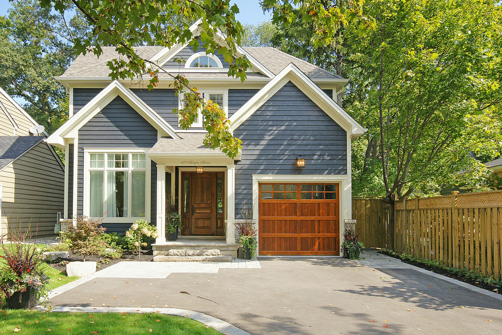 Traditional two-storey blue exterior in Toronto with a gable roof.