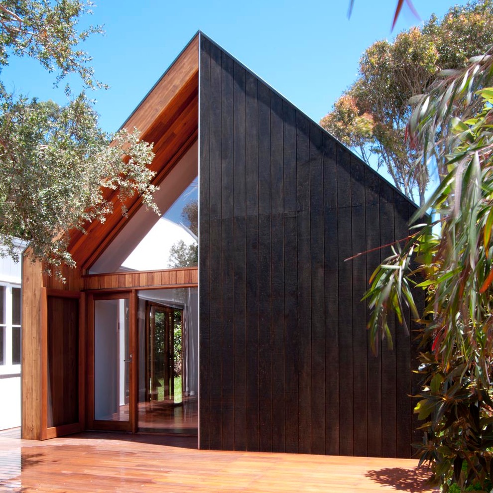 Inspiration for a small contemporary one-storey exterior in Melbourne with wood siding and a gable roof.